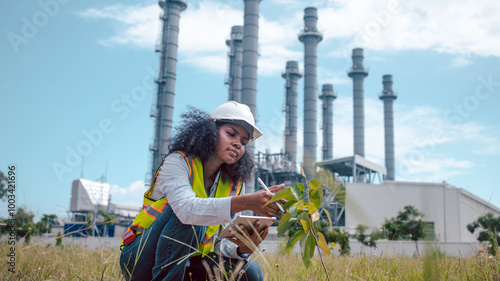 Engineers wear safety gear inspecting or document related to plants environment features large industrial chimneys related energy industrial work and environmental monitor carbon credit concept. photo