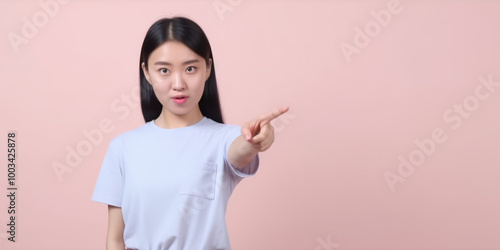 Young Woman Pointing Finger at Blank Space