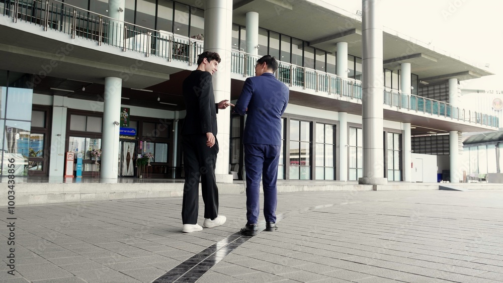 Two young business man in formal meeting and discussing documents and using a tablet in modern office, businessman planning with partner or consulting, business and team concept. Two young business man in formal meeting and discussing documents and using a tablet in modern office, businessman planning with partner or consulting, business and team concept.