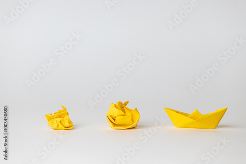 Success transformation and Transform to succeed or improving concept and leadership in business through innovation and evolution with paper origami changed for the better. yellow crumbed paper, boat