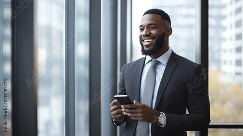 Professional Man Smiling with Smartphone in Modern Office