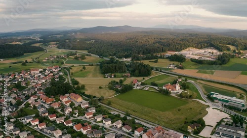 Aerial view of village in Slovenia, road, mountains, fields