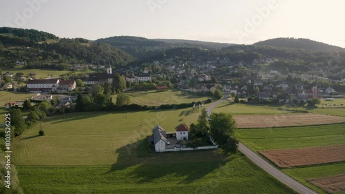 Aerial view of village in Slovenia, road, mountains, fields