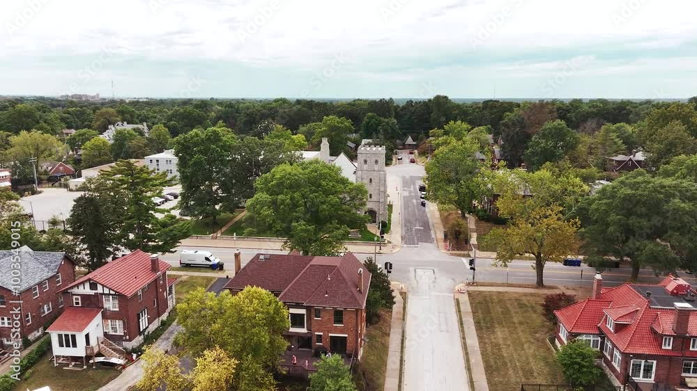 Drone video circling an old brick catholic or cathedral church inside a neighborhood. Drone video circling an old brick catholic or cathedral church inside a neighborhood.