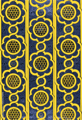  close-up of a decorative wall with intricate floral patterns in blue and yellow, creating a symmetrical and rhythmic design.