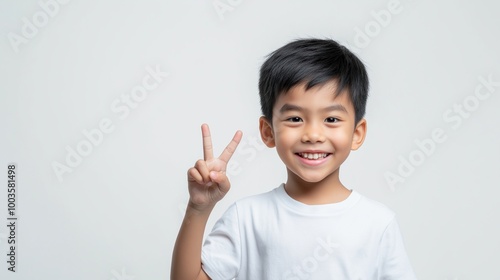 Asian boy with two fingers hand sign