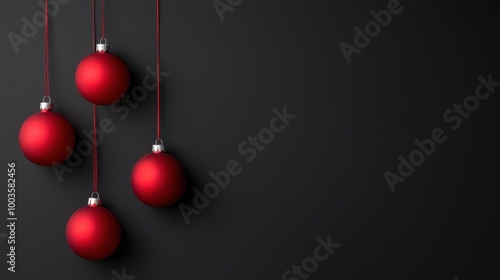 Four red Christmas ornaments hang against a dark background, creating a festive and elegant atmosphere.