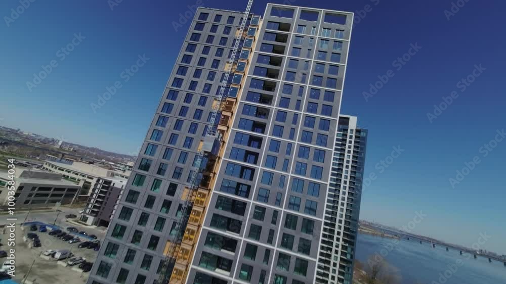 Residential Tower Under Construction At Nuns' Island Near Saint Lawrence River In Montreal, Canada. FPV drone shot Residential Tower Under Construction At Nuns' Island Near Saint Lawrence River In Montreal, Canada. FPV drone shot