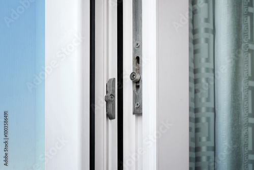 Close-up of the lock mechanism of a metal-plastic window.