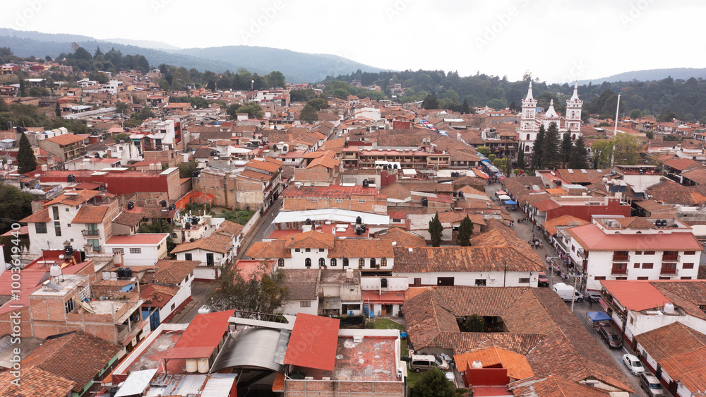 Fototapeta premium Mazamitla, Jalisco, Mexico - December 23, 2023: Cloudy afternoon sun shines on the historic city center.