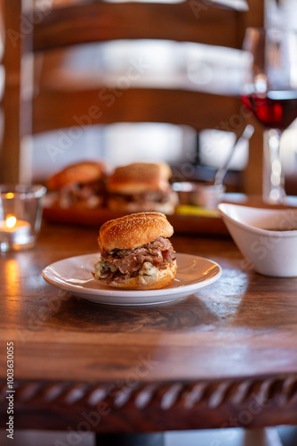 A roast beef slider sandwich on wooden table vertical