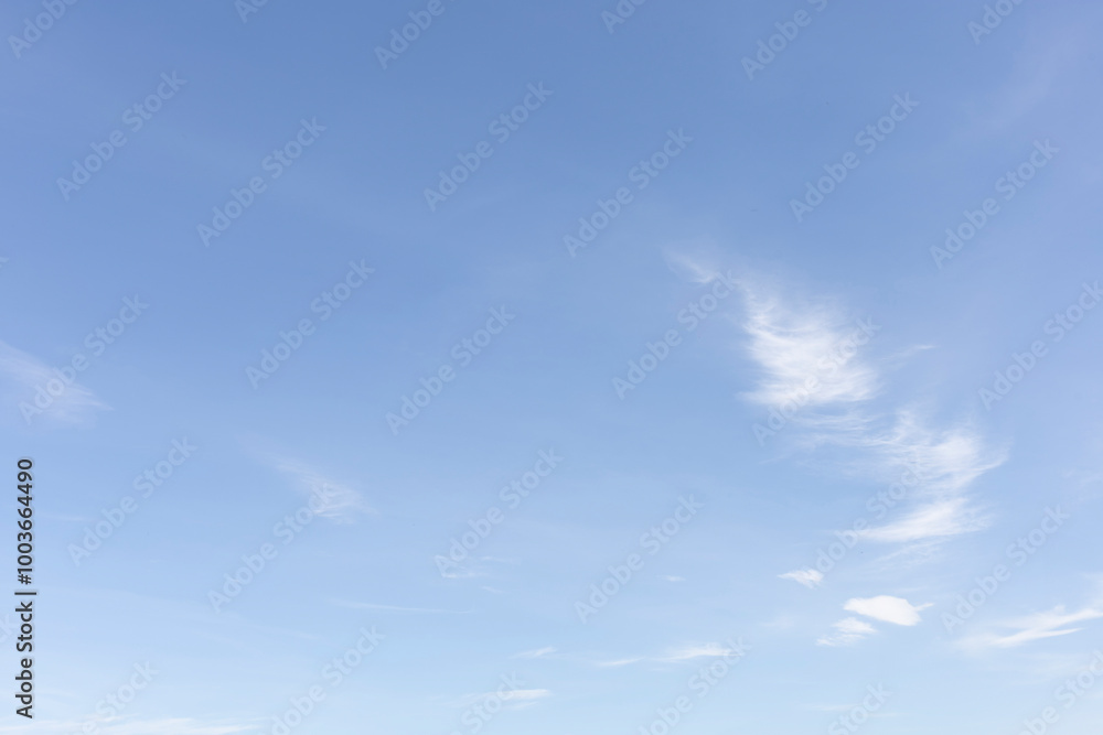 The clear blue sky with white clouds provides a bright and sunny background, enhancing the natural beauty of the landscape on this pleasant summer day The clear blue sky with white clouds provides a bright and sunny background, enhancing the natural beauty of the landscape on this pleasant summer day
