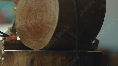 Old school woodworking by using a hand saw to cut a wooden log. Filmed in 4k 59.94 FPS