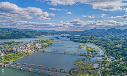 Dumulmeoli, Yangsu-ri, Yangpyeong-gun, Gyeonggi-do, South Korea - May 20, 2020: Aerial view of houses of a small island and bridges on Bukhangang River photo