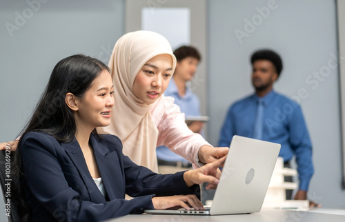 Muslim businesswoman in hijab presenting data charts and world map in a meeting, business presentation, professional teamwork, analysis, data-driven strategy, diverse workplace, business communication