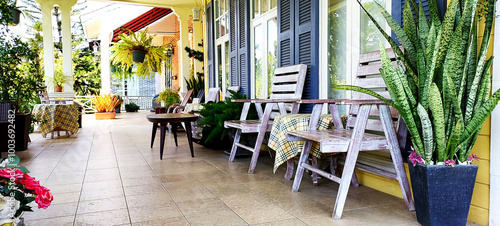 terrace decoration using ceramic floor tiles wood chairs set and plant pots create a point of interest, architecture concept © apithana
