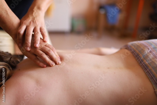Wallpaper Mural the hands of the massage therapist massage the back, spine, neck and shoulder area Torontodigital.ca