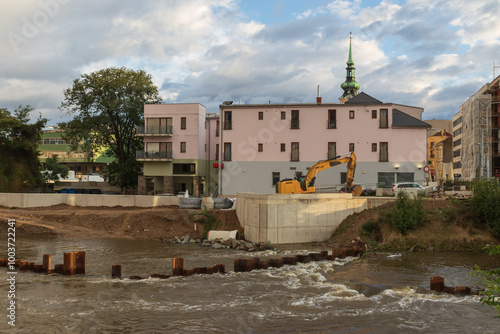 Yellow excavator on the bank of the river Svratka, Brno, Czech republic, floods after storm Boris, September 15, 2024.