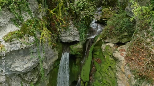 Crane up tilt down drone shot of beautiful waterfall Tine de Conflens in Vaud Switzerland photo