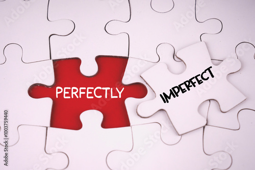 Motivational and inspirational words. PERFECTLY IMPERFECT written on jigsaw puzzle pieces.