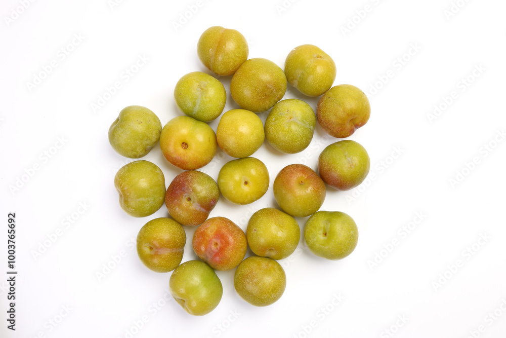 Ripe sweet small mini plum green maroon on white background Ripe sweet small mini plum green maroon on white background