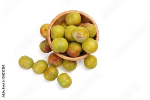 Ripe sweet small mini plum green maroon on white background photo