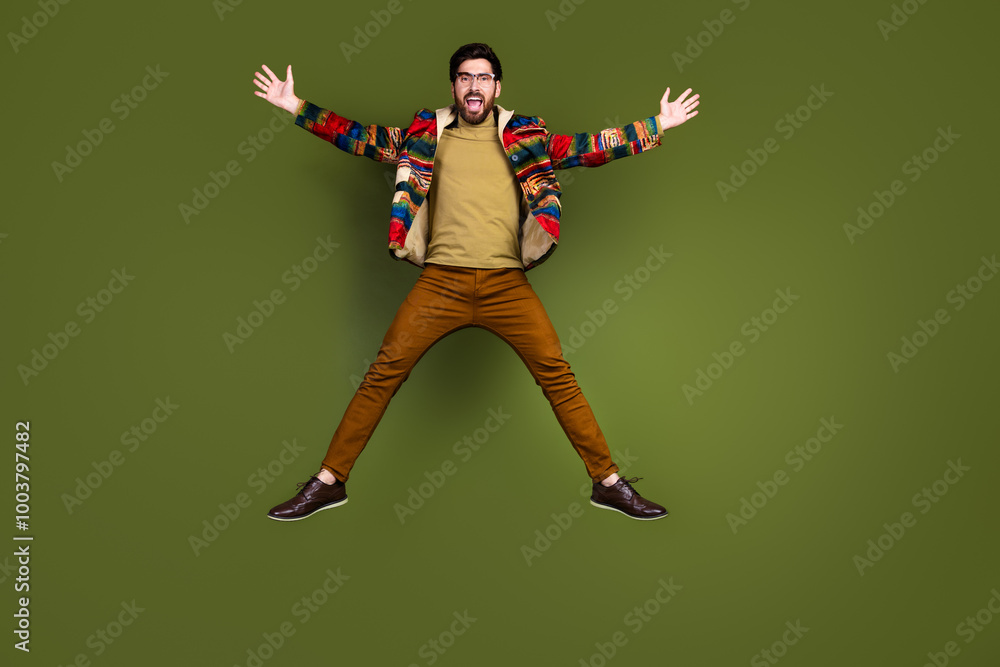 Photo of overjoyed cheerful crazy man wear stylish clothes open hands isolated on khaki color background Photo of overjoyed cheerful crazy man wear stylish clothes open hands isolated on khaki color background