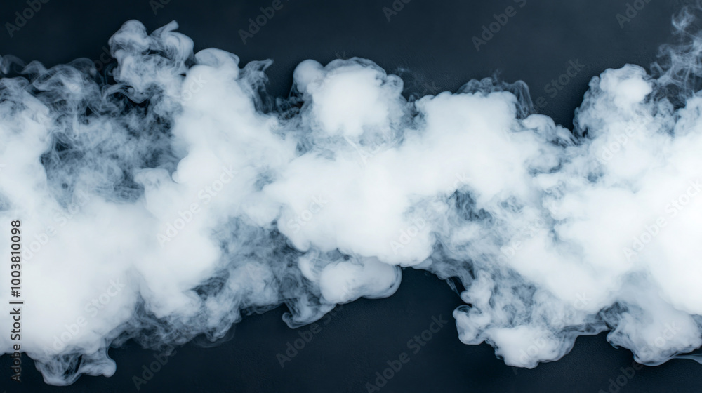 Thick white smoke billows across a dark background creating a mystical atmosphere Thick white smoke billows across a dark background creating a mystical atmosphere