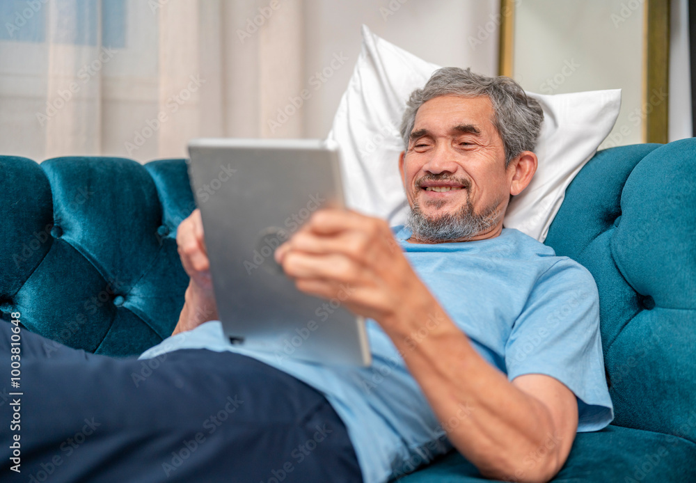 senior man relaxing on sofa using tablet online computer communicate with family at home,elderly lifestyle,technology senior man relaxing on sofa using tablet online computer communicate with family at home,elderly lifestyle,technology
