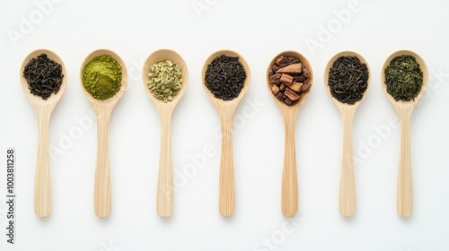 Top view of wooden spoons filled with different types of tea, including matcha and green tea,