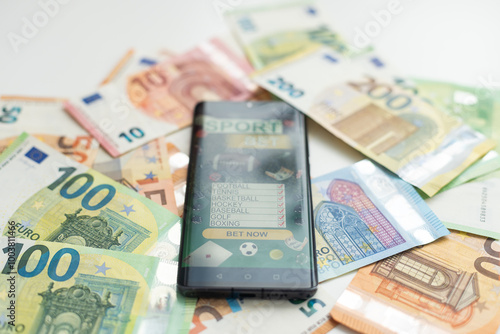 Behang Sports betting website in a mobile phone screen, money