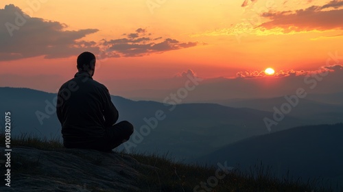 Man Sitting Peacefully on Mountaintop at Dawn