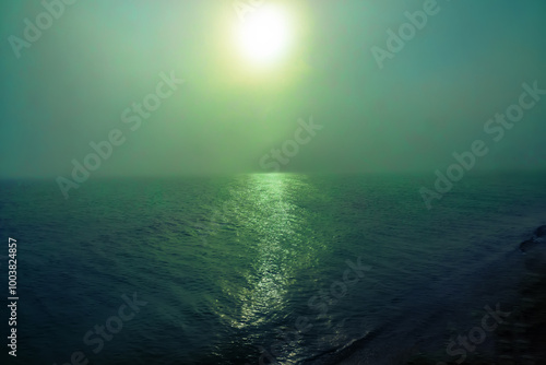 Fog over the sea and the morning sunrise, gloomy morning. Exfoliation, advection fog - cooling of warm moist air when it moves over a colder surface of lwater photo