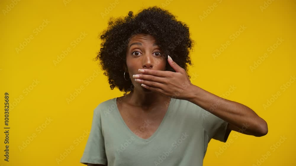 Surprised Young Woman Covering Mouth Against Yellow Background Surprised Young Woman Covering Mouth Against Yellow Background