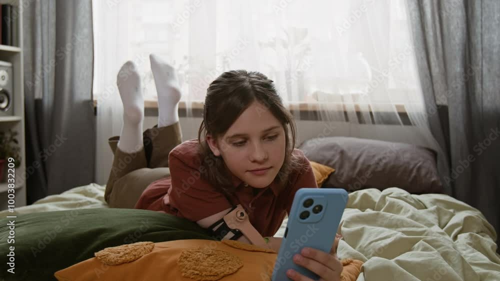 Relaxed girl with disability using smartphone in bed Relaxed girl with disability using smartphone in bed