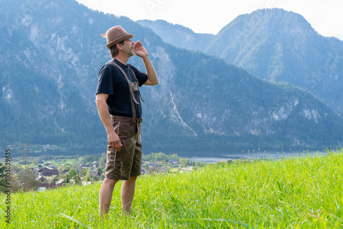 An elderly Tyrolean man, 50-55 years old, wearing traditional clothes, sings and shouts against the backdrop of a village surrounded by mountains,  photo