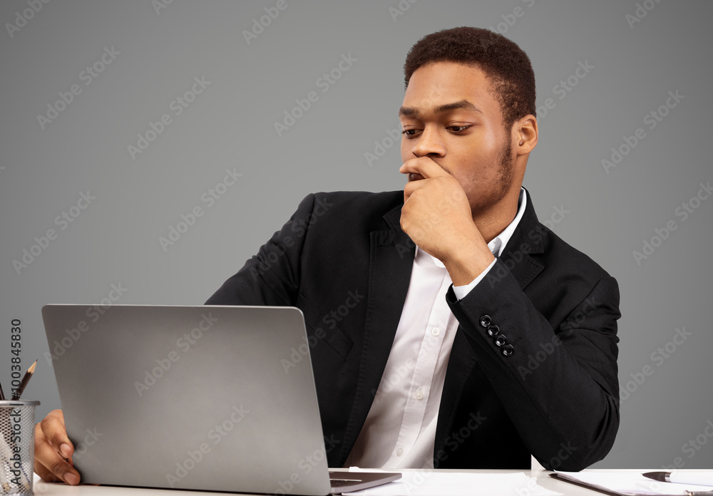 Focused Man. Portrait of afro businessman using laptop, watching webinar to improve skills, copyspace, white wall Focused Man. Portrait of afro businessman using laptop, watching webinar to improve skills, copyspace, white wall