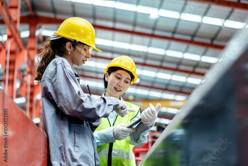 Female worker in safety uniform together work inspecting operation manufacturing Metal Roofing Sheet Machine in the factory metal sheet, Metalwork roof manufacturing and quality control process.