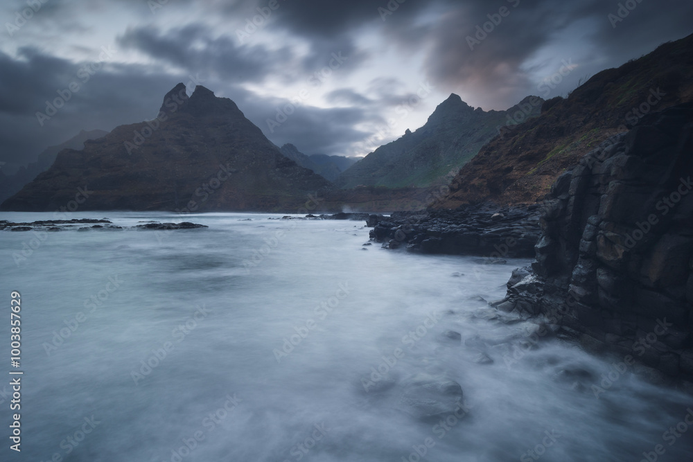 Rocky coastline in Punta del Hidalgo in Tenerife- taken on long exposure time. Dramatic sky add a mood to this picture.