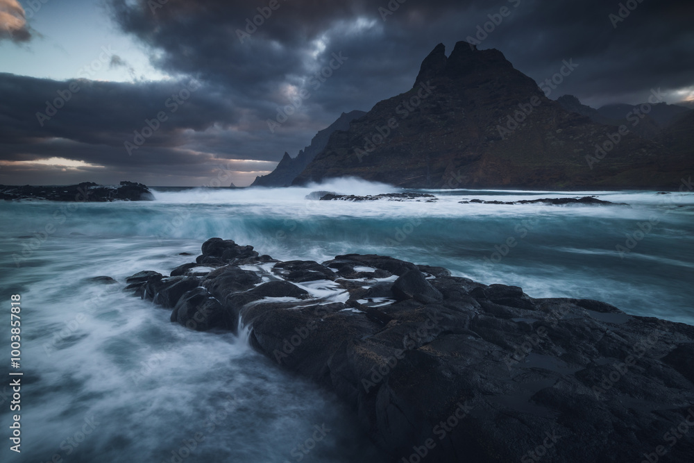 Rocky coastline in Punta del Hidalgo in Tenerife- taken on long exposure time. Dramatic sky add a mood to this picture.