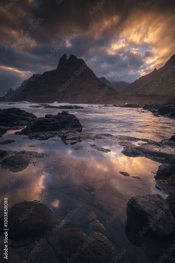 Rocky coastline in Punta del Hidalgo in Tenerife- taken on long exposure time. Dramatic sky add a mood to this picture.