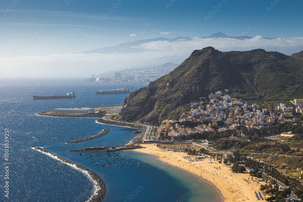 Playa de Las Teresitas captured on a warm sunny day, with the Teide volcano visible in the background.