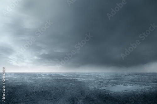 A wet, muddy field with cloudy and dark sky background