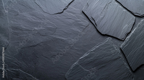 Textured arrangement of dark slate stone pieces on a rustic background at natural light photo