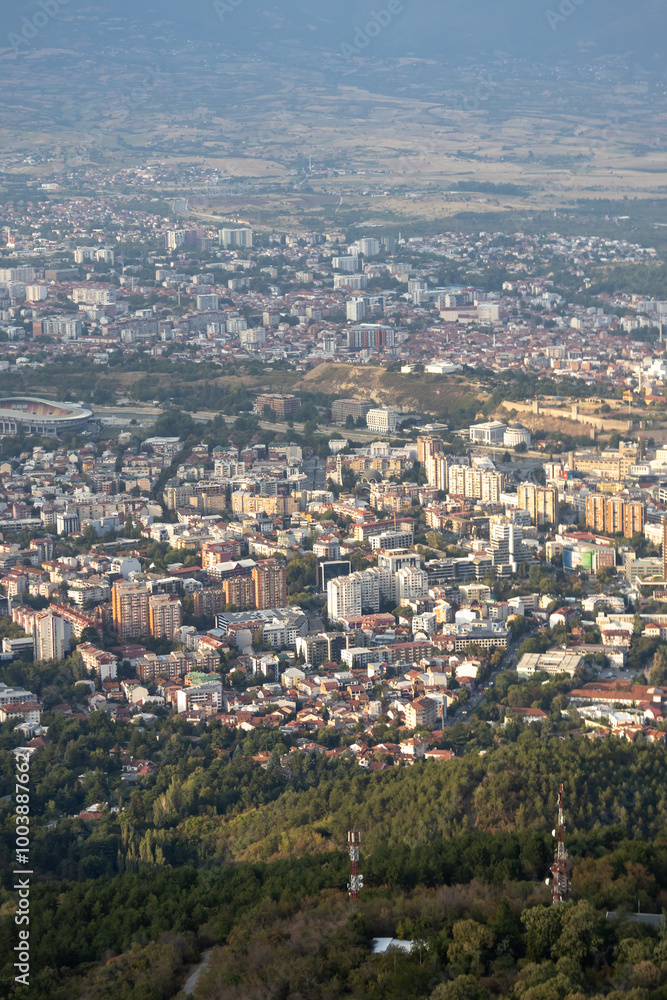 Dramatic cityscape panorama overlooking green hills Dramatic cityscape panorama overlooking green hills