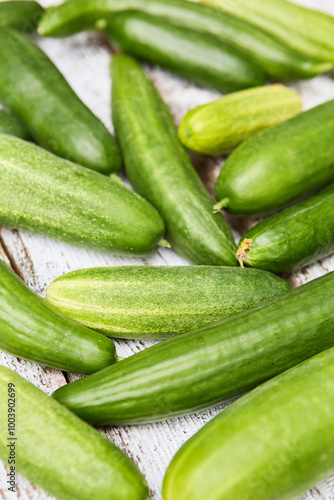 Fresh green cucumbers on rustic wooden background showcasing organic summer harvest