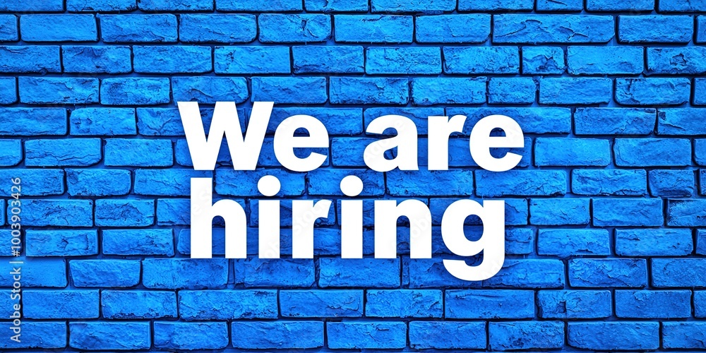 Obraz premium We are hiring text on the blue brick wall. Concept of employment. Generative Ai
