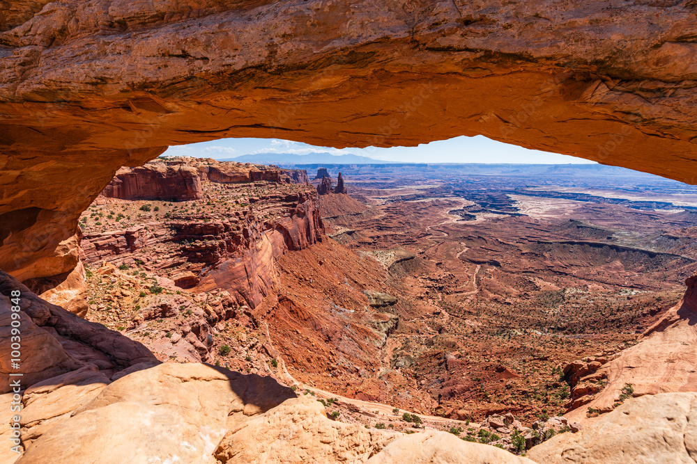 The most famous landmark of the Island in the Sky District of Canyonlands national park in Utah USA - The Mesa Arch in a blue day.