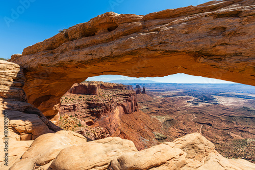 The most famous landmark of the Island in the Sky District of Canyonlands national park in Utah USA - The Mesa Arch in a blue day.