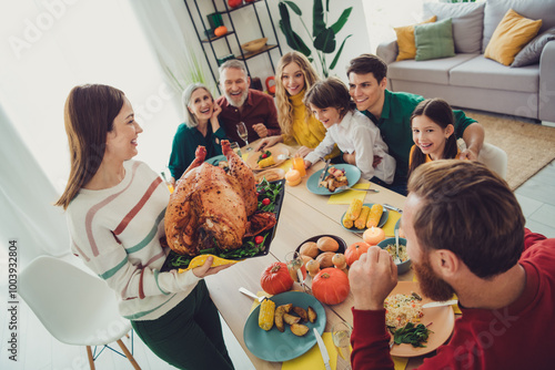 Photo of happy nice people celebrating thanksgiving day together serving main dish stuffed turkey indoors photo